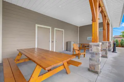 a porch with a wooden table and two chairs at Days Inn & Suites by Wyndham Lindsay in Lindsay