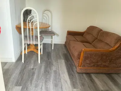 a living room with a couch and a table at Woodland Cedars Family Cottage Resort in Wasaga Beach