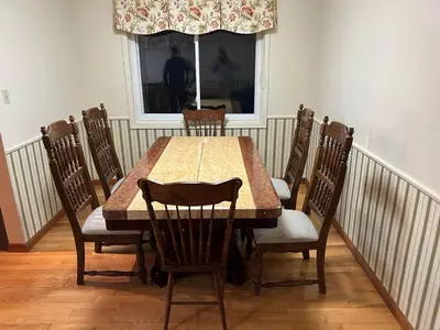 a dining room table with chairs and a window at Charming Farmhouse in Grafton