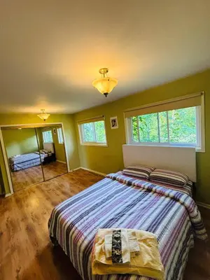 a bedroom with two beds and a large window at Charming Farmhouse in Grafton