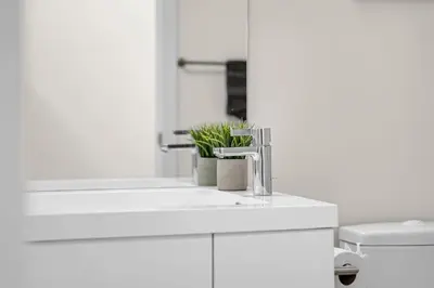 a white bathroom with a sink and a toilet at Luxe 5bd Unit sleeps 11 - Hospitals MTCC TTC ACC in Toronto