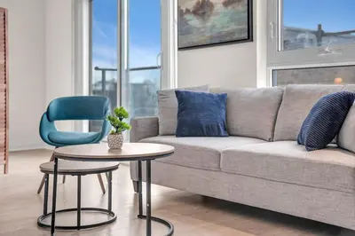 a living room with a couch and a table and a chair at Luxe 5bd Unit sleeps 11 - Hospitals MTCC TTC ACC in Toronto