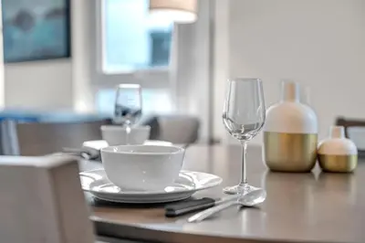 a table with a plate and a glass of wine at Luxe 5bd Unit sleeps 11 - Hospitals MTCC TTC ACC in Toronto