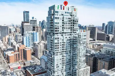 a view of a tall building in a city at Luxe 5bd Unit sleeps 11 - Hospitals MTCC TTC ACC in Toronto