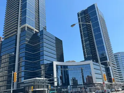 two tall skyscrapers in a city with a street at Condo at Yonge-Sheppard Station, North York in Toronto