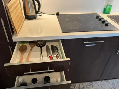 a kitchen with a stove top oven next to a counter at Condo at Yonge-Sheppard Station, North York in Toronto