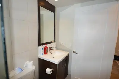 a bathroom with a sink and a mirror at Condo at Yonge-Sheppard Station, North York in Toronto