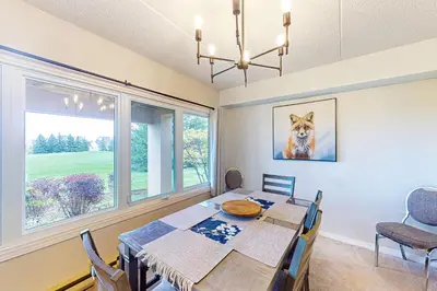 a dining room with a table and a large window at Wintergreen 122 in Blue Mountains