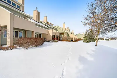 a snow covered driveway in front of a building at Wintergreen 122 in Blue Mountains