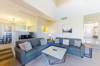 a living room with a couch and a table at Wintergreen 122 in Blue Mountains