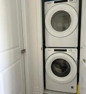 a washing machine and a washer in a room at Modern & Stylish Condo Downtown in Mississauga
