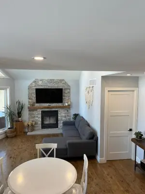 a living room with a couch and a fireplace at Wiley Woods Cottage in Minden