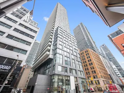a tall building in a city with tall buildings at The Aventi Suites - Downtown Toronto - Across TIFF Bell Lightbox in Toronto