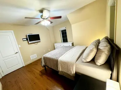a bedroom with a bed and a ceiling fan at Private Bright Coach House - Near Pearson Airport & Downtown Toronto in Brampton