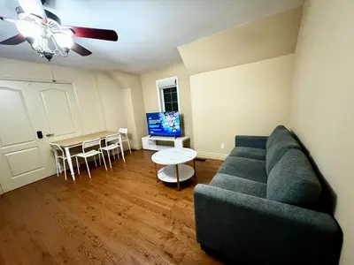 a living room with a couch and a table at Private Bright Coach House - Near Pearson Airport & Downtown Toronto in Brampton