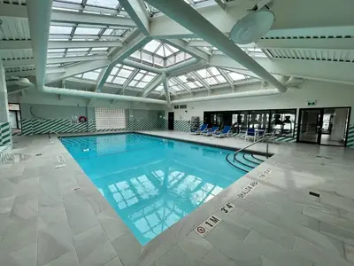 a large swimming pool in a building with a ceiling at Staybridge Suites Toronto Airport East by IHG in Toronto