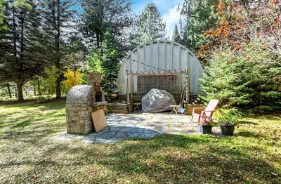 a fire pit in a yard with a building at Mono Farmhouse in Caledon