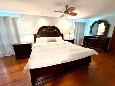 a bedroom with a large bed and a ceiling fan at Mono Farmhouse in Caledon
