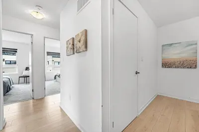 a room with white walls and a hallway with a door at Ritzy 3BR Home with Balcony Near Burlington Pier in Burlington