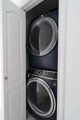 two washing machines and a washer and dryer in a room at Luxury 2 Bedroom 3 Bed Family Friendly Oasis with Smart Technology in Brampton