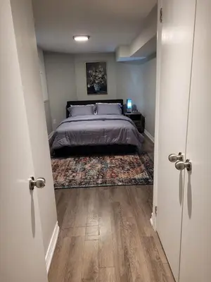 a bedroom with a bed and a rug at Cozy 2 Bed Rooms Apartment in Prime Location! in Mississauga
