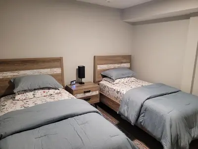 two beds sitting next to each other in a bedroom at Cozy 2 Bed Rooms Apartment in Prime Location! in Mississauga