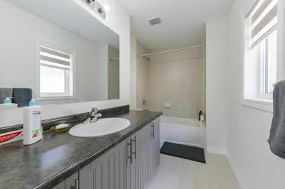 a bathroom with a sink and a bath tub at Entire 4BR Detached Home 15 Mins from the Falls, in Thorold, Perfect for 10 guests in Thorold