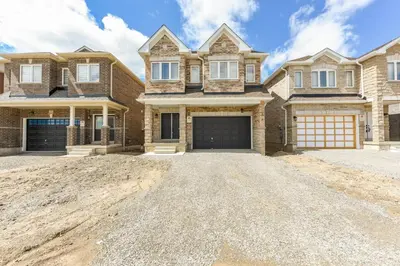 a large brick house with a garage at Entire 4BR Detached Home 15 Mins from the Falls, in Thorold, Perfect for 10 guests in Thorold