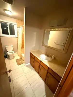 a bathroom with a sink and a toilet and a mirror at YKF Airport Home-FREE FAST WIFI-FREE PARKING in Hespeler