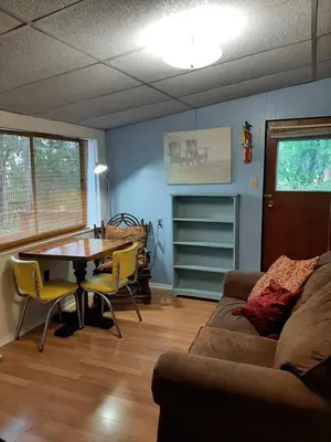 a living room with a couch and a table at Wymbolwood Lodge in Tiny