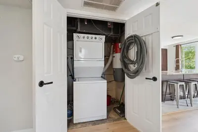 a kitchen with a stove and a white refrigerator at Wintergreen Spacious 2 Story Townhome Sauna 2 Min Walk to Village in Blue Mountains