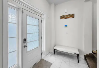 a white room with a bench and a window at Modern Comfort in Clarington in Newcastle