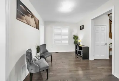 a living room with a table and chairs and a desk at Modern Comfort in Clarington in Newcastle