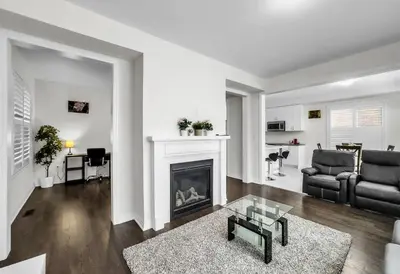 a living room with a fireplace and a couch at Modern Comfort in Clarington in Newcastle