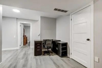 an office with a desk and a chair at Luxury & private 3 bed basement unit kitchen, wifi, park, mall in London