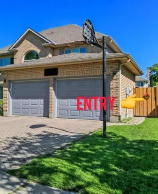a house with an entry sign in front of a garage at Luxury & private 3 bed basement unit kitchen, wifi, park, mall in London