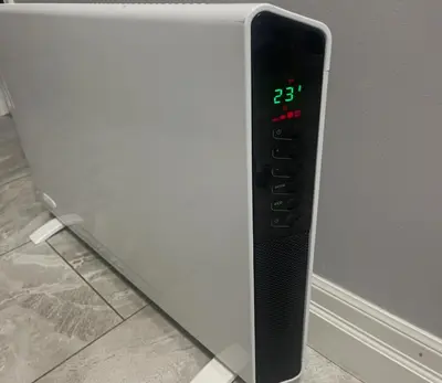 a digital clock on the side of a refrigerator at Luxury & private 3 bed basement unit kitchen, wifi, park, mall in London