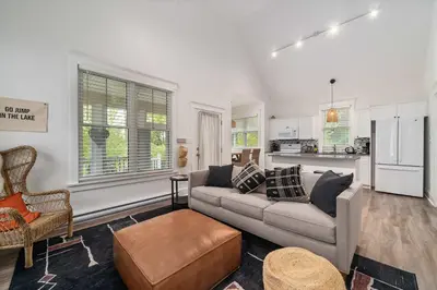 a living room with a couch and a kitchen at The Mayflower - 4 Pine Forest in Cherry Valley