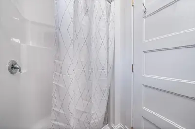 a shower with a white door in a bathroom at The Mayflower - 4 Pine Forest in Cherry Valley