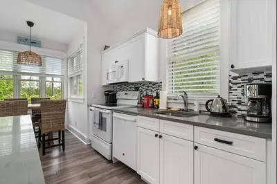a kitchen with white cabinets and a counter top at The Mayflower - 4 Pine Forest in Cherry Valley
