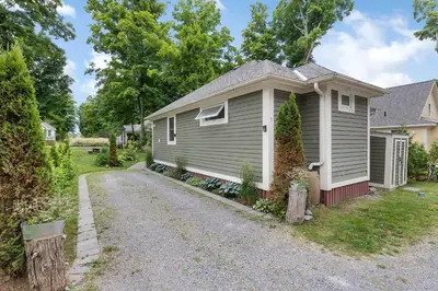 a small house with a gravel road in front of it at The Cardinal - 7 Hollow in Cherry Valley