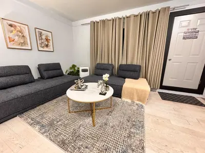 a living room with a couch and a table at Steps to Bars & Fun in Port Credit in Mississauga