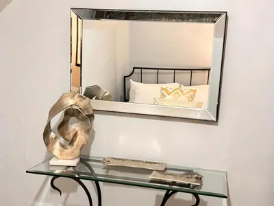 a glass table with a mirror on a wall at Steps to Bars & Fun in Port Credit in Mississauga