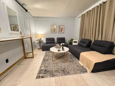 a living room with a couch and a table at Steps to Bars & Fun in Port Credit in Mississauga