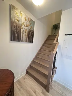 a staircase in a house with a painting on the wall at 2bedroom Townhome in South Richmond Hill in Richmond Hill