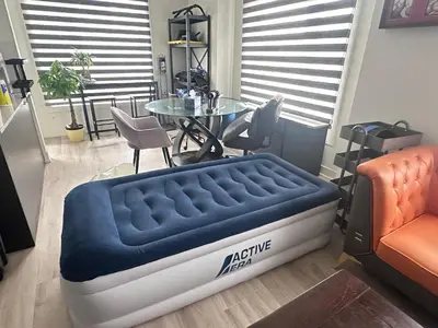 a bed sitting in a room with a table at 2bedroom Townhome in South Richmond Hill in Richmond Hill