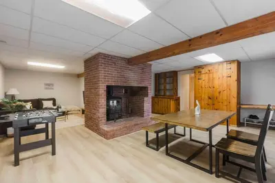 a living room with a brick fireplace and a table at Villa Marina Haven private Waterfront in Port Carling