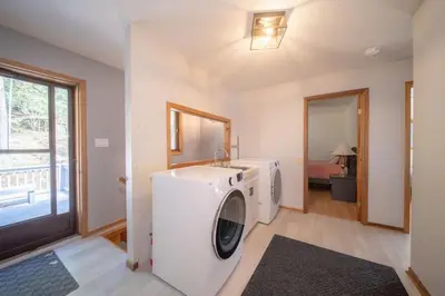 a laundry room with a washing machine and a sink at Villa Marina Haven private Waterfront in Port Carling