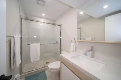 a bathroom with a shower and a sink and a toilet at Villa Marina Haven private Waterfront in Port Carling