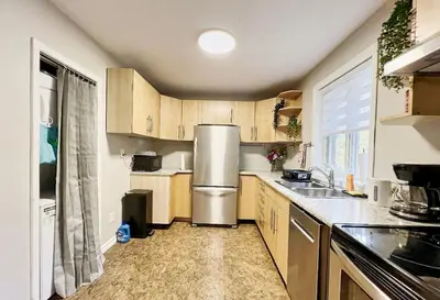 a kitchen with wooden cabinets and a stainless steel refrigerator at Canada WonderLand Stay-Superb Location in Vaughan